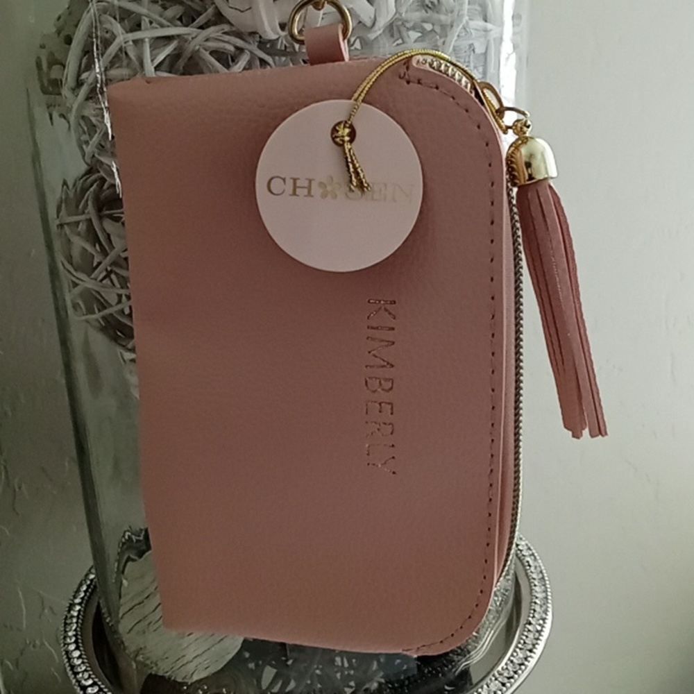 NWT. Pink coin purse w strap.
